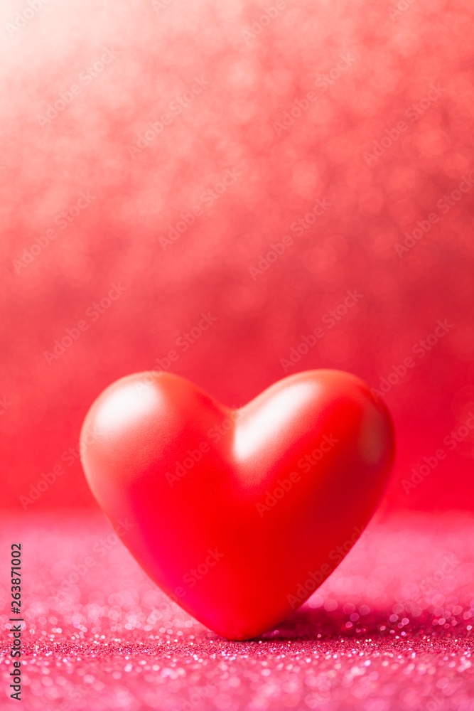 Red heart on red blurred abstract background Red heart on red blurred abstract background