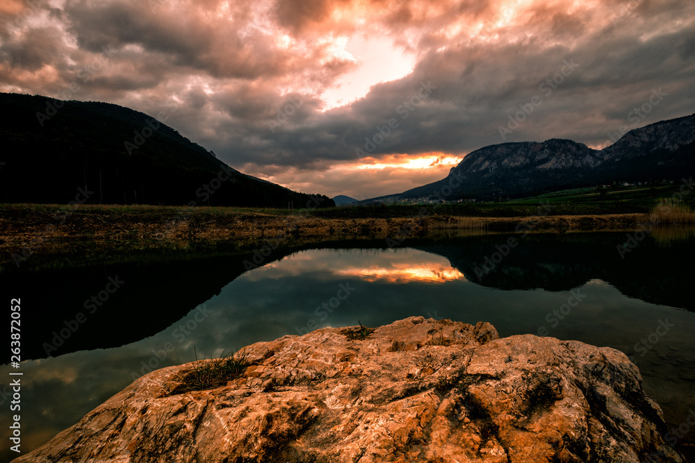 Small lake in austrian mountains at the sunset