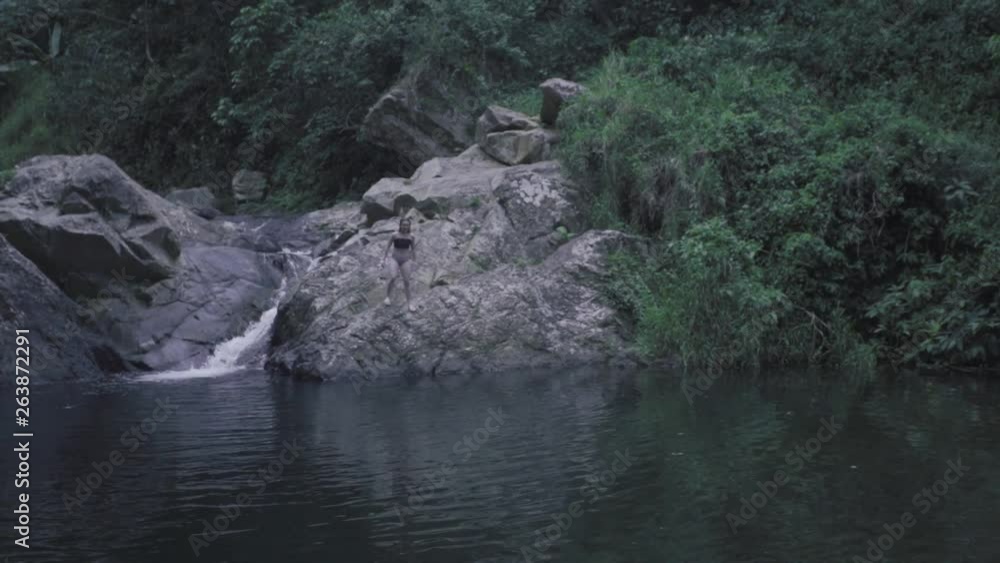 SLOW MOTION: girl dives into the base of Mango Waterfall in Adjuntas, Puerto Rico. SLOW MOTION: girl dives into the base of Mango Waterfall in Adjuntas, Puerto Rico.