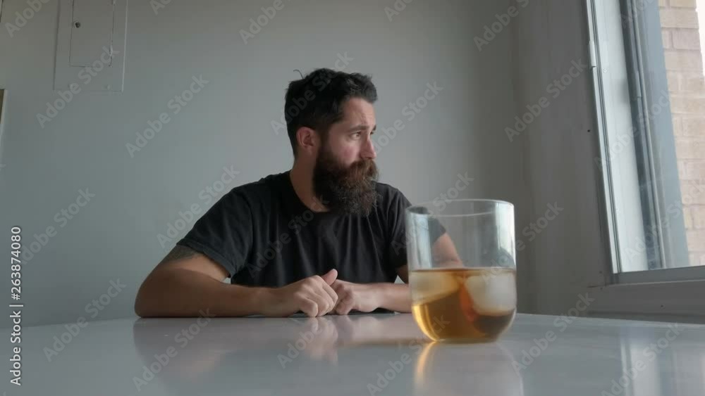 drunk middle-aged man trying to resist drinking a glass of whisky 4k drunk middle-aged man trying to resist drinking a glass of whisky 4k