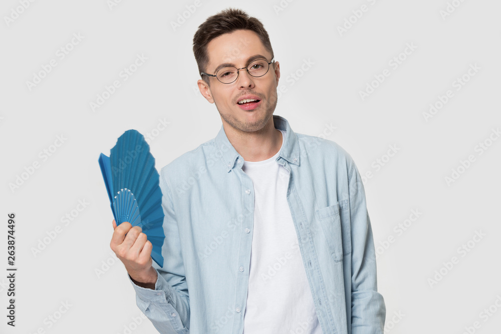 Funny Caucasian man in glasses using hand fan looking cool Funny Caucasian man in glasses using hand fan looking cool