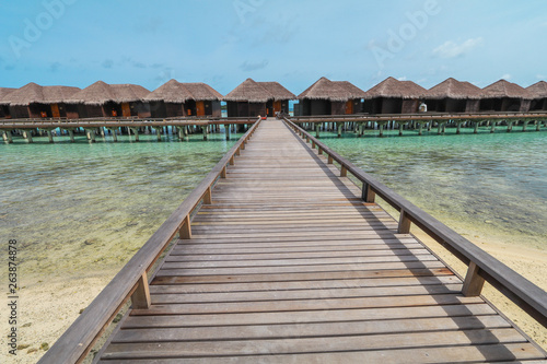 Amazing island in the Maldives ,water villa ,wooden bridge and  beautiful  turquoise waters with  blue sky  background for holiday vacation . © Umarin