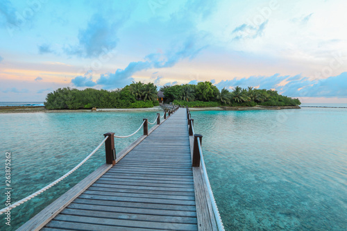 Fototapeta Naklejka Na Ścianę i Meble -  Amazing island in the Maldives ,wooden bridge and  beautiful  turquoise waters with  blue sky  background for holiday vacation .