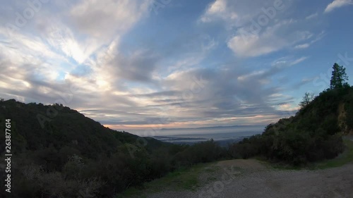 Time lapse of moving clouds and sunrise in the hills above Santa Barbara in California photo