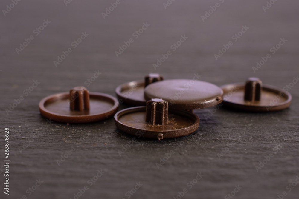 Group of five whole brown plast plugs work item on grey stone Group of five whole brown plast plugs work item on grey stone
