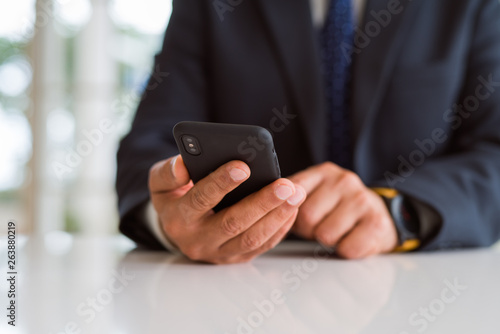 Close up of business man hands using smarpthone