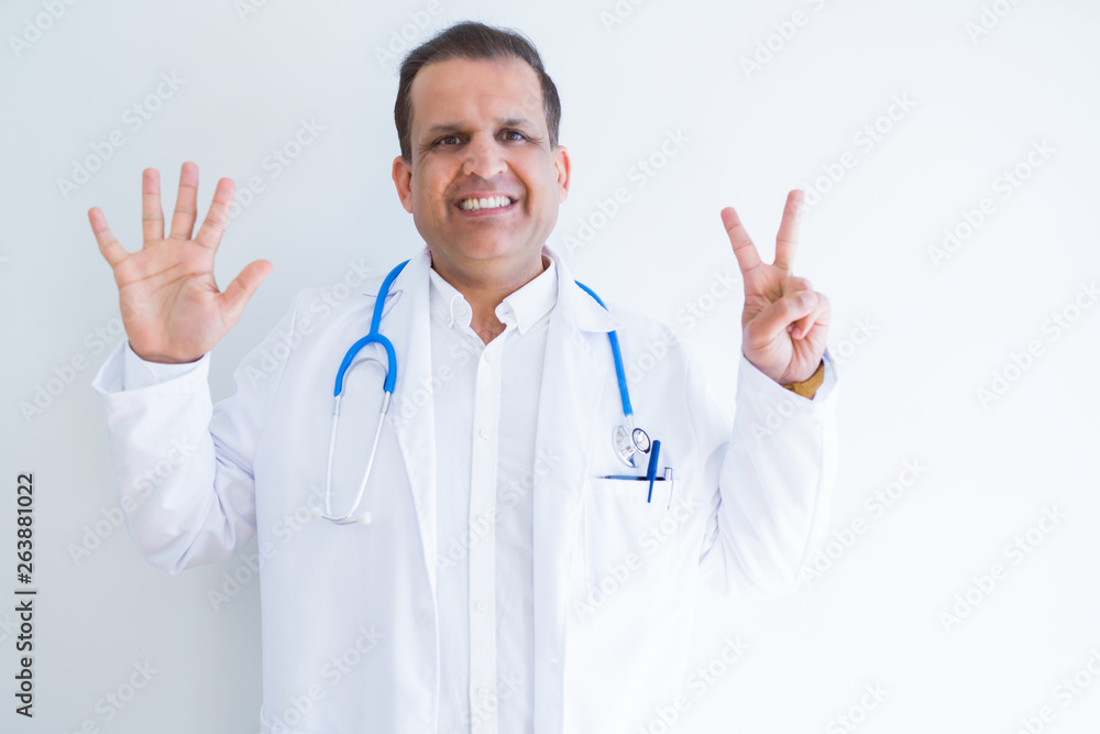 Middle age doctor man wearing stethoscope and medical coat over white background showing and pointing up with fingers number seven while smiling confident and happy. Middle age doctor man wearing stethoscope and medical coat over white background showing and pointing up with fingers number seven while smiling confident and happy.