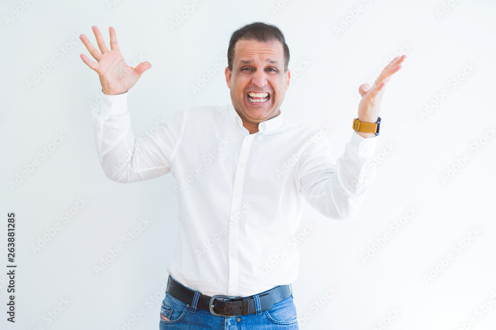 Middle age man celebrating and screaming happy for succesful win Middle age man celebrating and screaming happy for succesful win