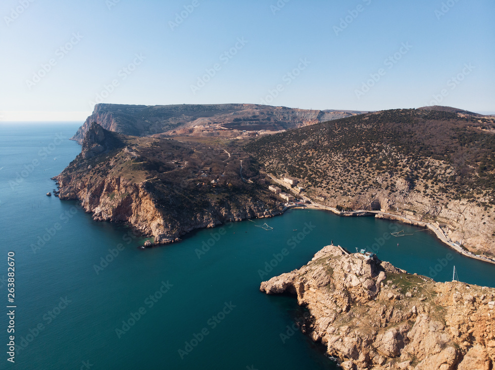 Aerial view of rocky mountain coastline and sea harbor, summer travel destinations concept