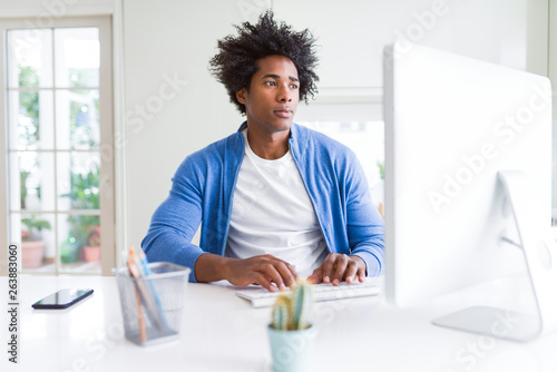 African American man working using computer with a confident expression on smart face thinking serious