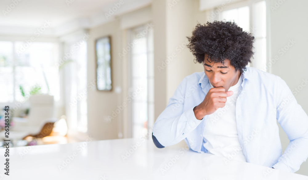 African American man at home feeling unwell and coughing as symptom for cold or bronchitis. Healthcare concept. African American man at home feeling unwell and coughing as symptom for cold or bronchitis. Healthcare concept.