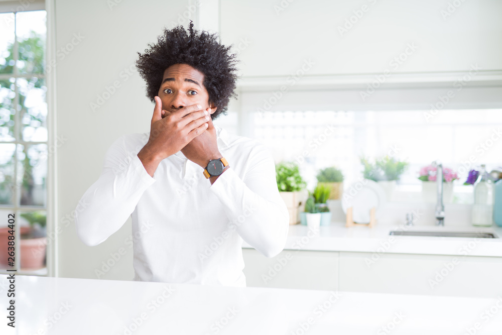 African American man shocked covering mouth with hands for mistake. Secret concept. African American man shocked covering mouth with hands for mistake. Secret concept.