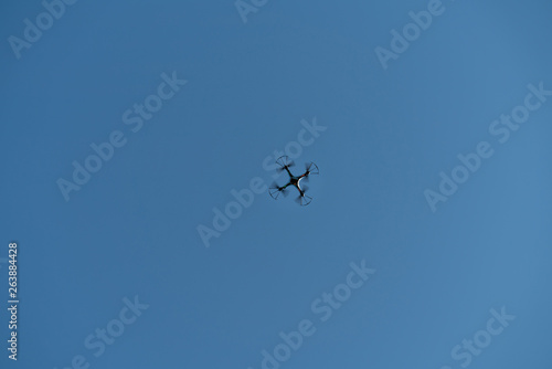 Drone flying in the air against the blue sky.technology and radio-controlled machines