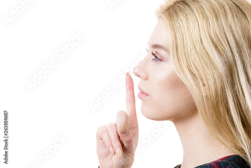 Woman showing silence gesture