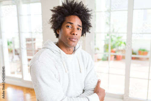 African American man wearing sweatshirt Relaxed with serious expression on face. Simple and natural with crossed arms