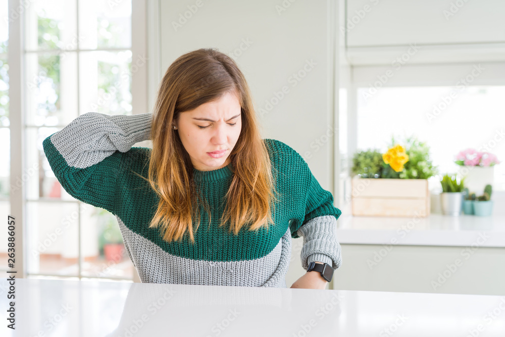 Young beautiful plus size woman wearing casual striped sweater Suffering of neck ache injury, touching neck with hand, muscular pain Young beautiful plus size woman wearing casual striped sweater Suffering of neck ache injury, touching neck with hand, muscular pain