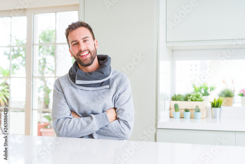 Handsome man at home happy face smiling with crossed arms looking at the camera. Positive person.