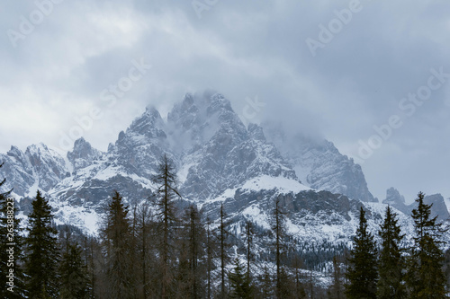 Alps, Dolomites, Italy view of mountains in clouds in winter.