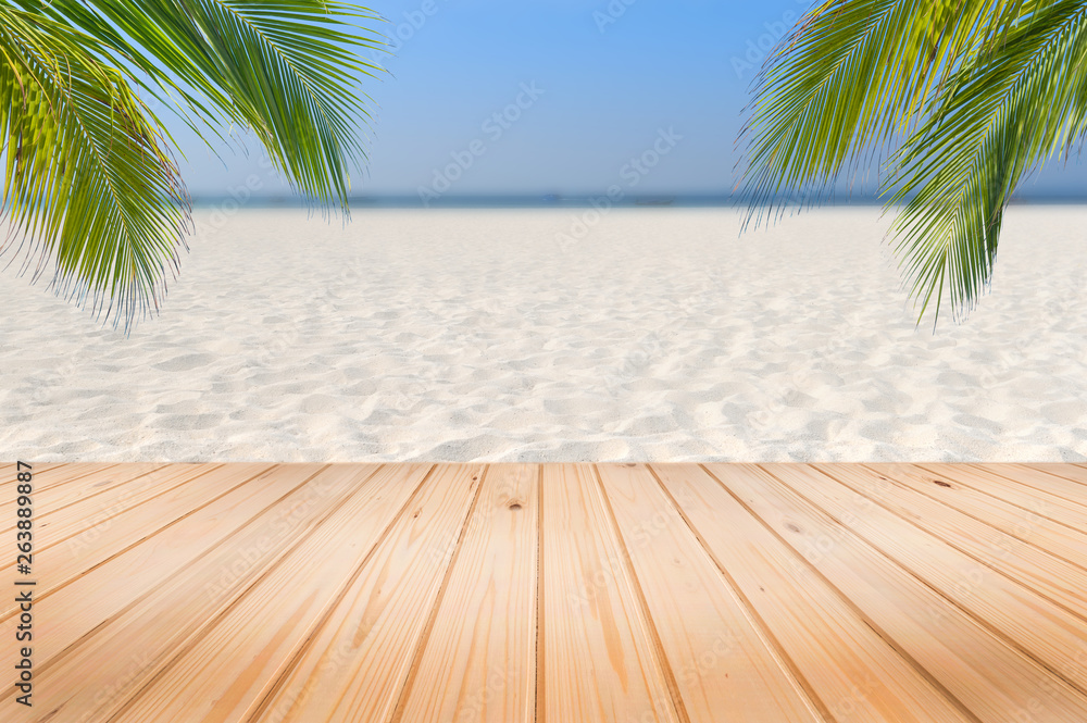 Wooden desk or plank on sand beach in summer. background. For product display.