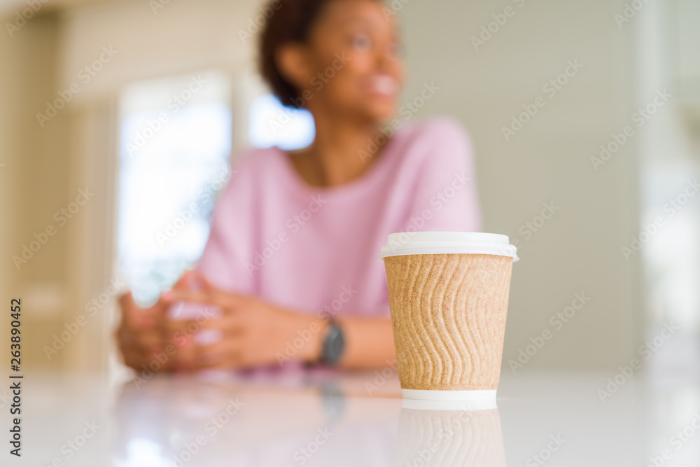 Beautiful youn woman with afro hair drinking a coffee in a take away paper cup Beautiful youn woman with afro hair drinking a coffee in a take away paper cup