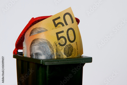 Fifty Australian dollar notes in a garbage bin.
