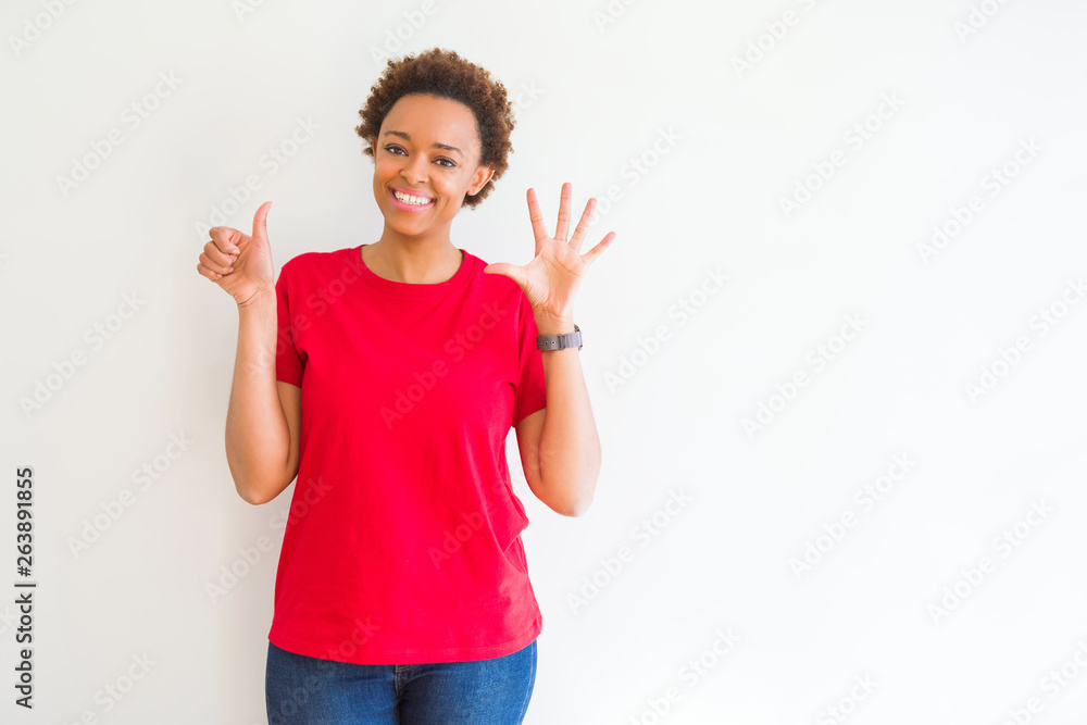 Young beautiful african american woman over white background showing and pointing up with fingers number six while smiling confident and happy. Young beautiful african american woman over white background showing and pointing up with fingers number six while smiling confident and happy.