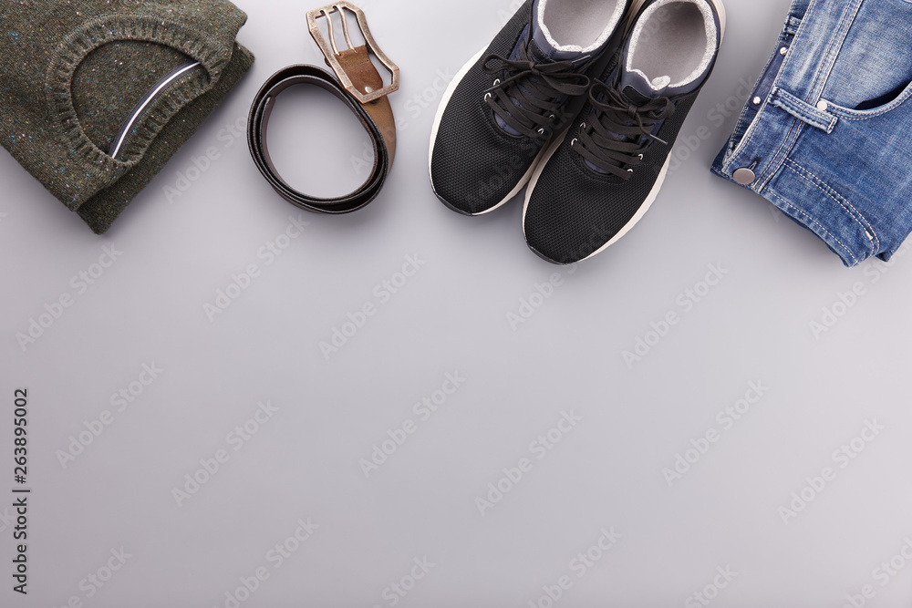 Mens summer casual clothes flat lay on gray Mens summer casual clothes flat lay on gray