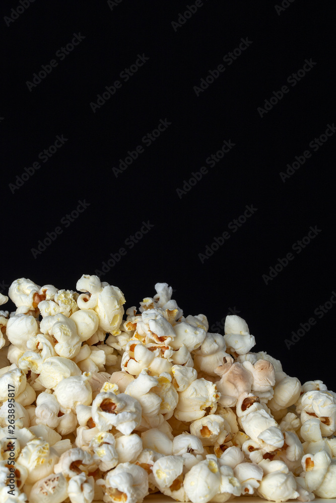 Popcorn close up with black background for text copy Popcorn close up with black background for text copy