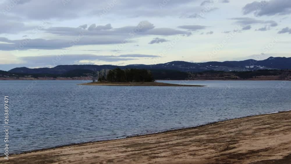 Aerial view of isolated small forest island in a lake with birds Aerial view of isolated small forest island in a lake with birds