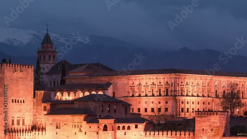 Sunset with the Alhambra of Granada as main subject. Beautiful clouds and Sierra Nevada in the background.
