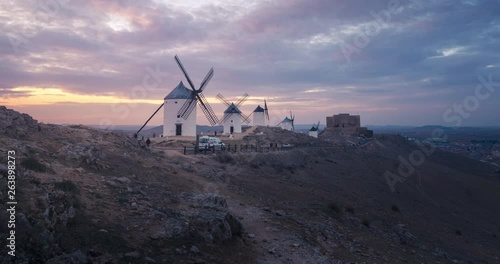 Windmills in Consuegra, Castilla La Mancha during sunset. Clouds with beautiful colors at golden hour.