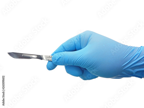 Hand of surgeon in blue medical glove holding a scalpel with blade isolated on white background with clipping path