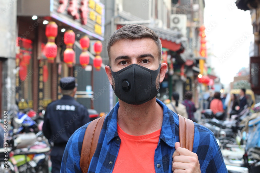 Caucasian man wearing pollution mask in Asia Caucasian man wearing pollution mask in Asia