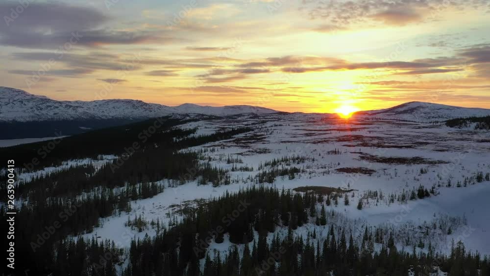 Aerial view of a mountain range in northern Sweden at sunset 