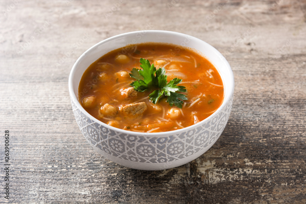 Harira soup in bowl on wooden table. Typical Moroccan food. Ramadán concept. Harira soup in bowl on wooden table. Typical Moroccan food. Ramadán concept.
