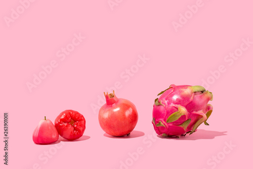 Exotic Tropical Fruits on Pink Background - Pomegranate, Pitaya, Dragonfruit, Jambu photo