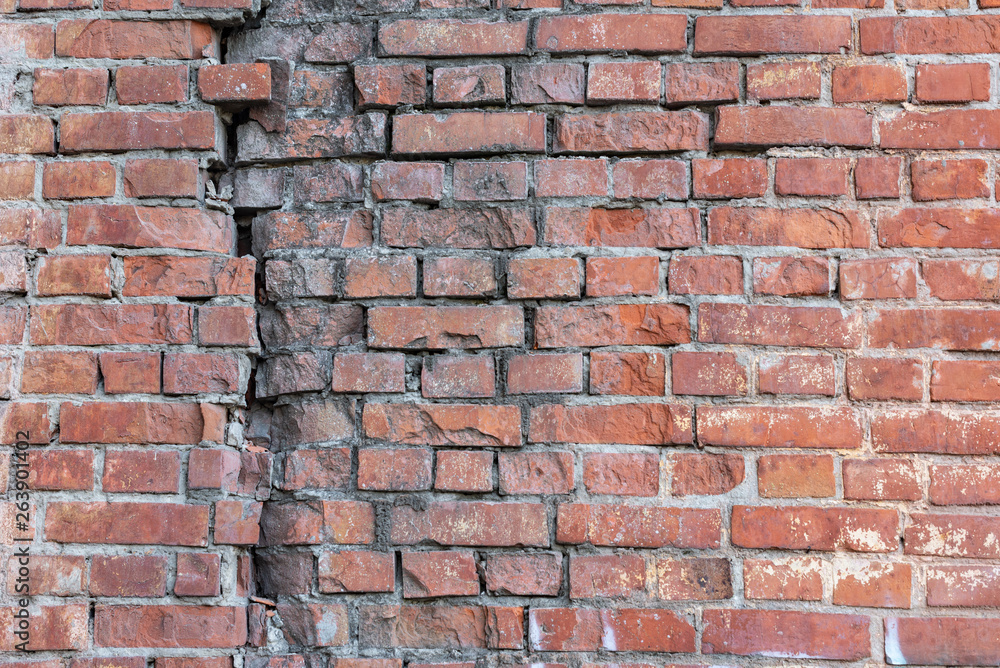 Fototapeta premium The brick texture, wall, with cracks and scratches can be used as a background