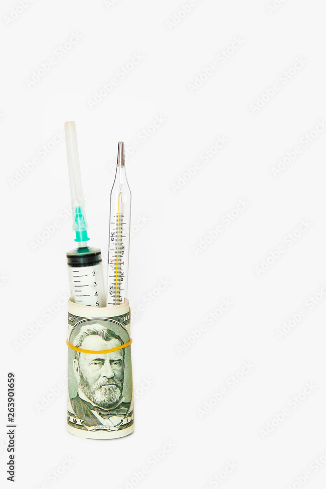 medical syringe and thermometer in a roll of dollars on a white background medical syringe and thermometer in a roll of dollars on a white background