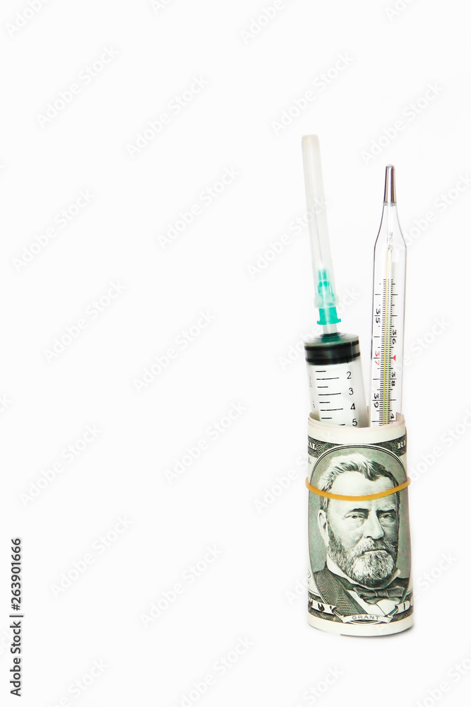 medical syringe and thermometer in a roll of dollars on a white background medical syringe and thermometer in a roll of dollars on a white background