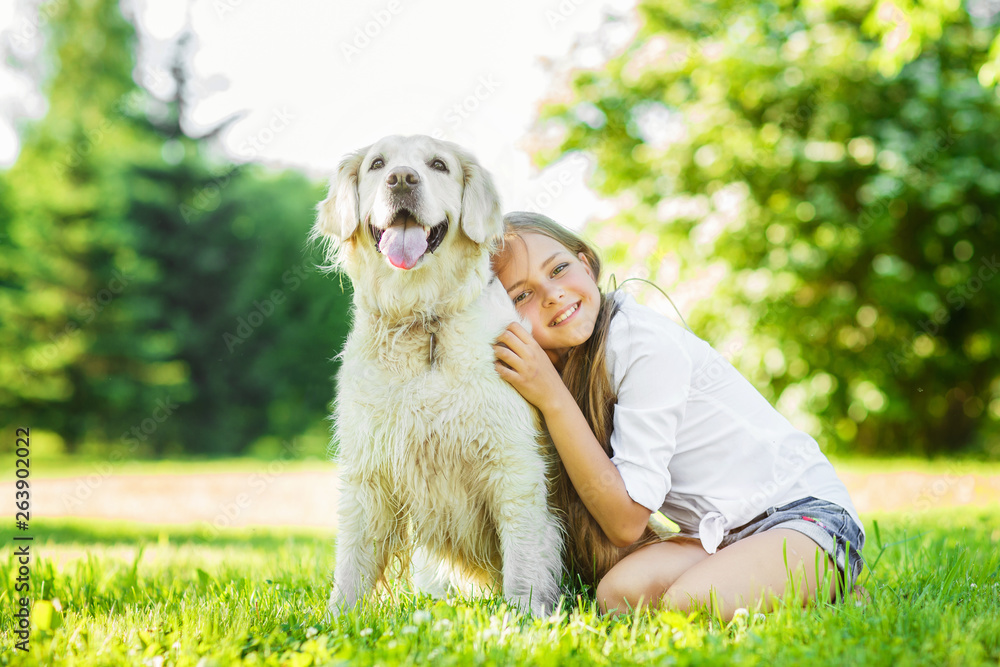 Teen girl with golden retriever dog in the park Teen girl with golden retriever dog in the park