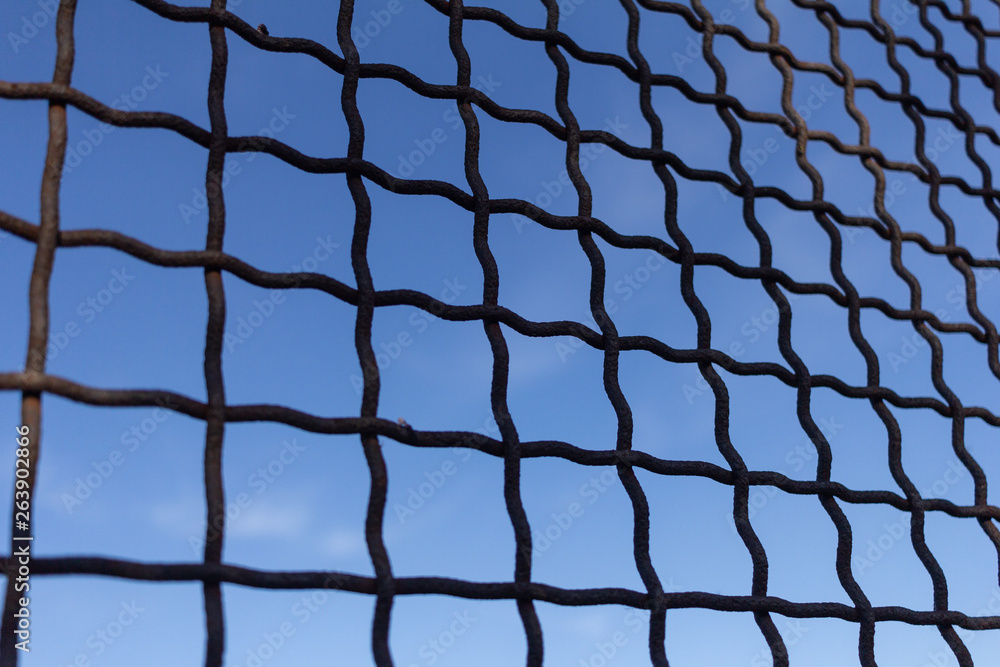 Fototapeta premium Protective mesh on a blue background