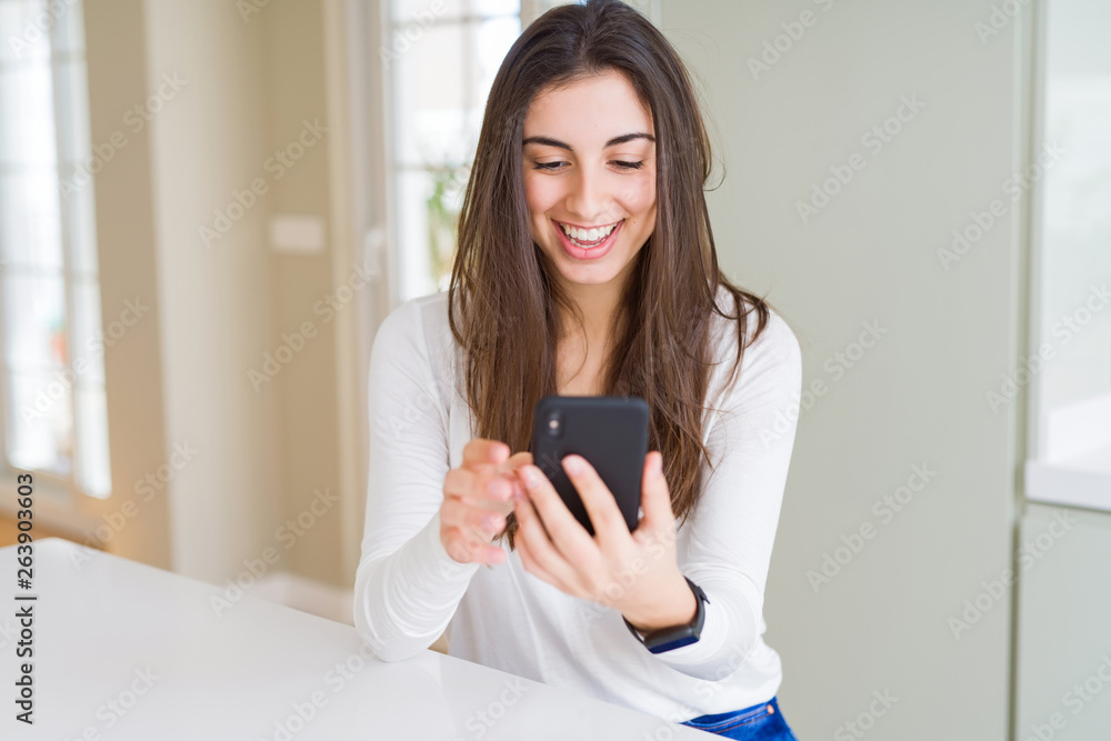 Young woman using smartphone, smiling happy texting and typing Young woman using smartphone, smiling happy texting and typing