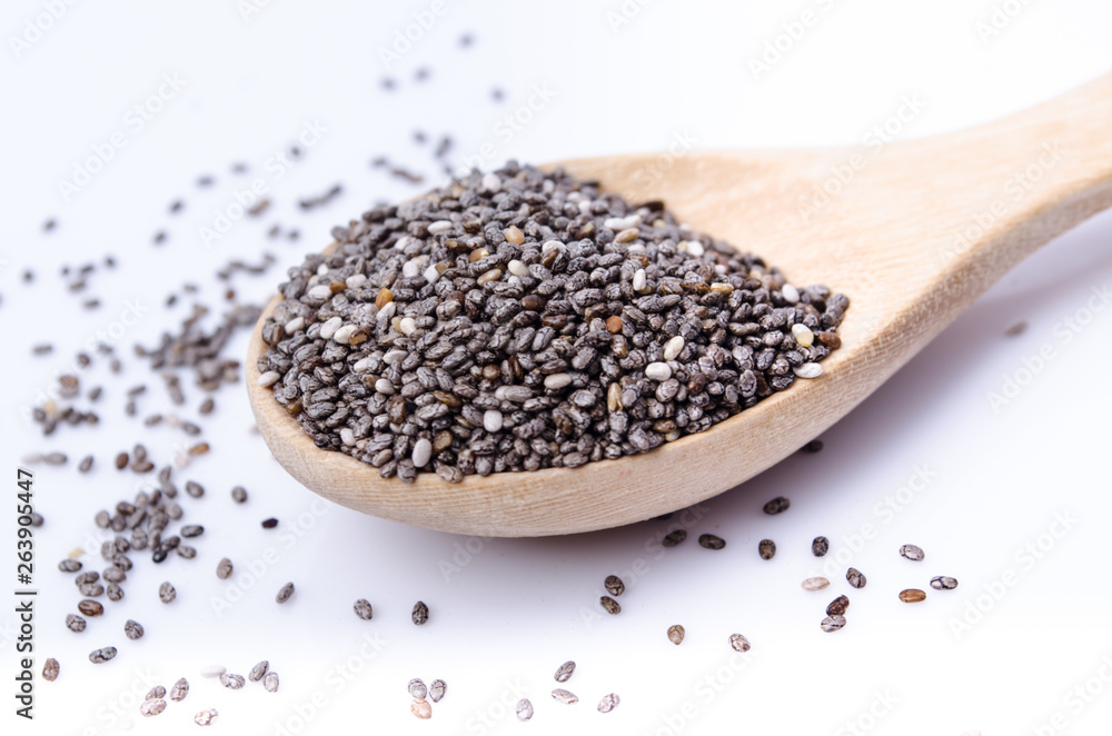 chia seeds in a wooden scoop isolated on white chia seeds in a wooden scoop isolated on white
