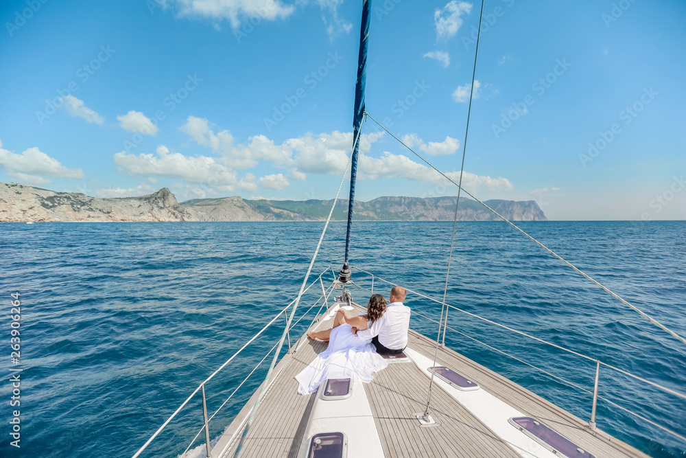 A Just married couple on yacht. Happy bride and groom on their wedding day A Just married couple on yacht. Happy bride and groom on their wedding day