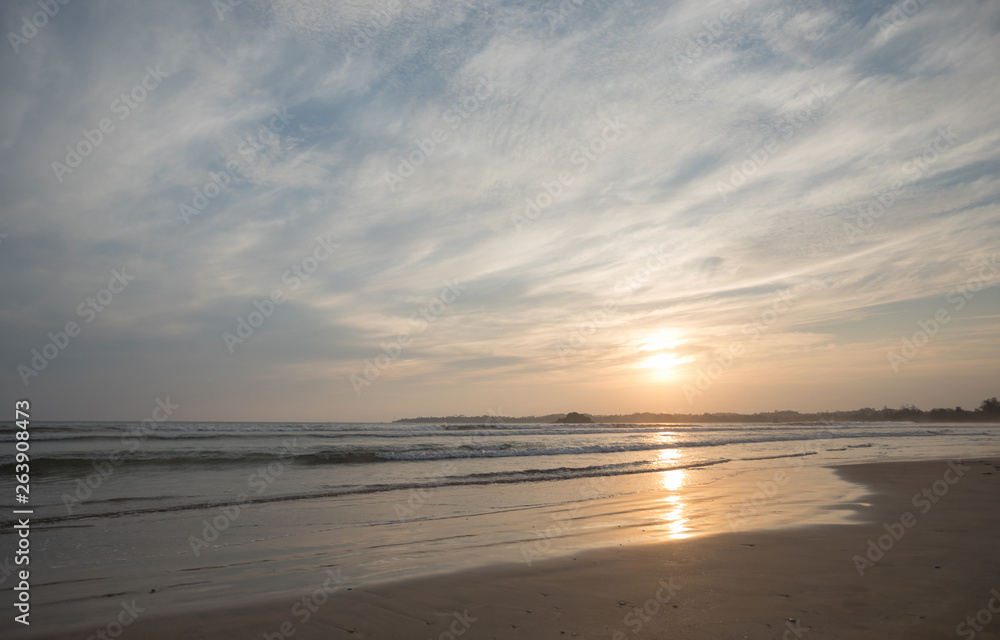 Landscape of tropical island beach with palm trees in the sunrise