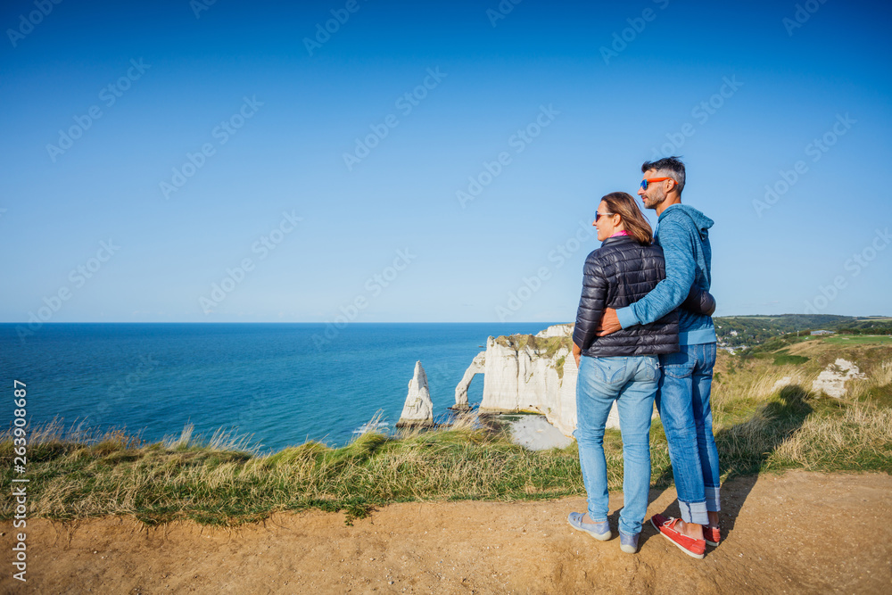 Happy couple walking in the Etretat. France