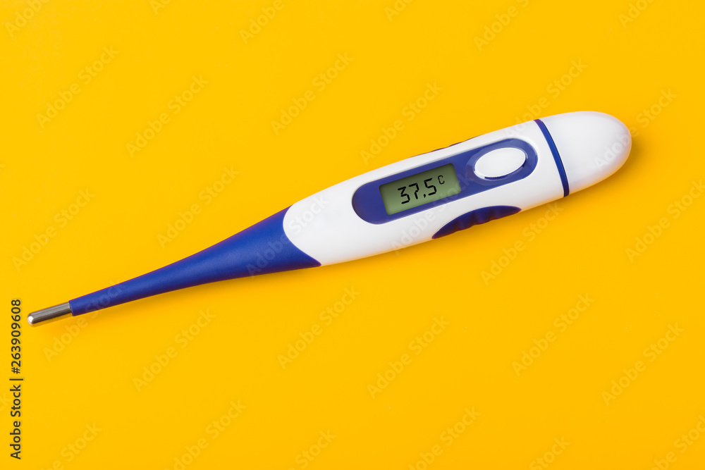 Electronic medical thermometer (37.5 degrees) on yellow background Electronic medical thermometer (37.5 degrees) on yellow background