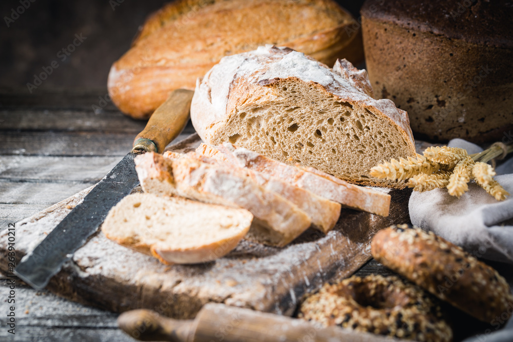 Fresh homemade slice bread and knife on rustic table Fresh homemade slice bread and knife on rustic table