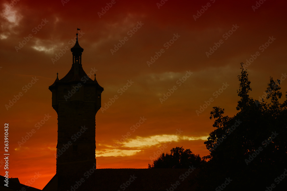 silhouette Klingen Tower in  Rothenburg ob der Tauber, Germany by night. Red sunset 