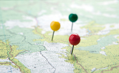 topographic map with colored needles pushpins close up